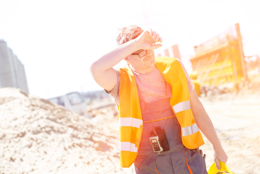 Construction worker sweating under the sun - Beat the Heat How to Stay Cool at a Construction Site