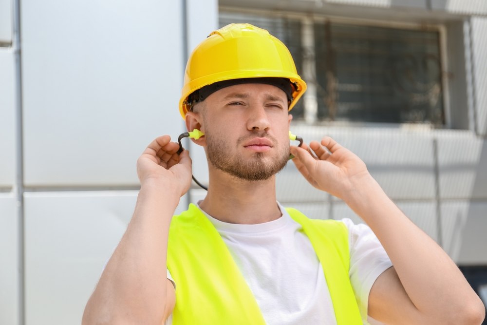 Construction worker with ear plugs
